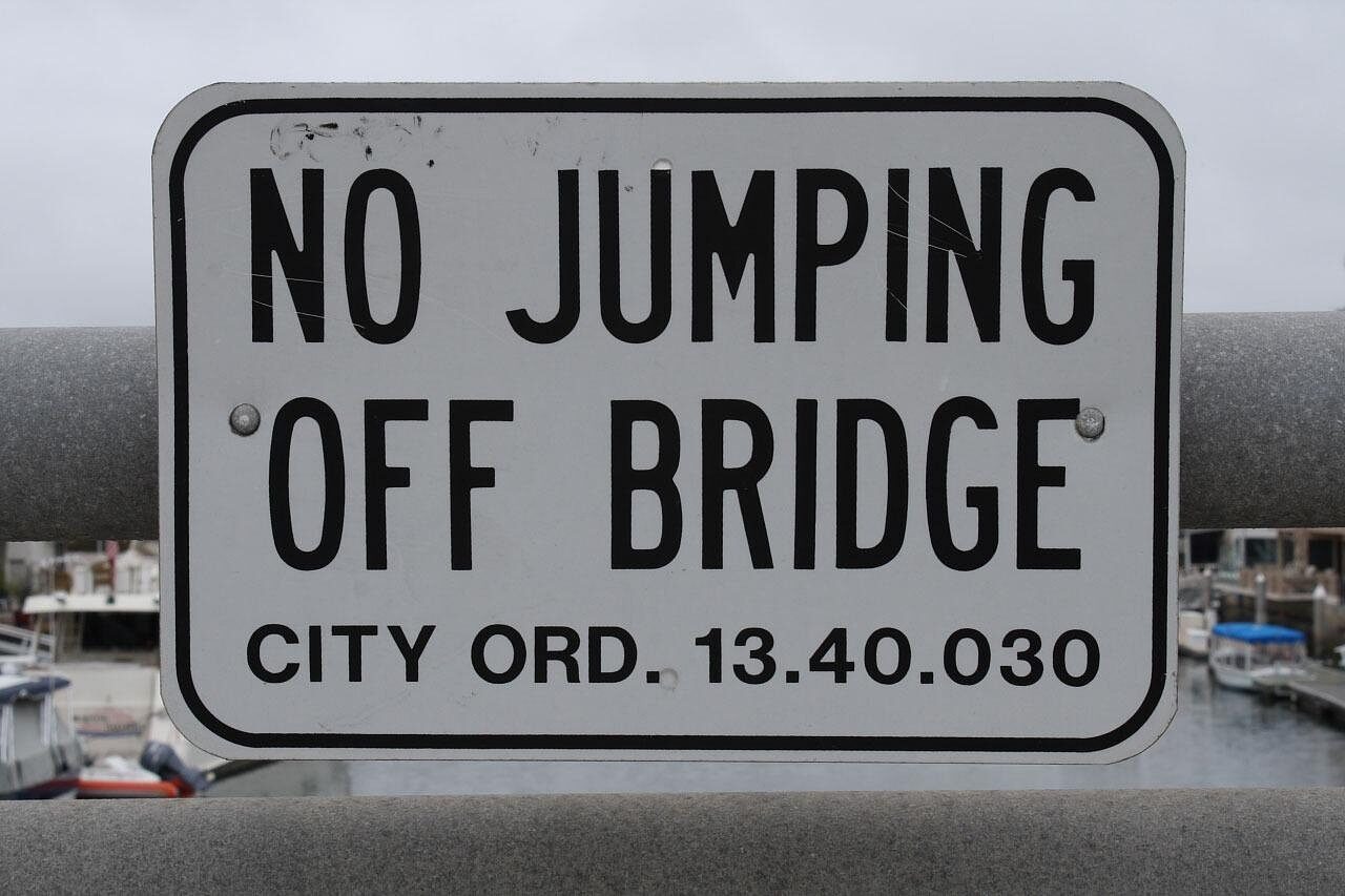 No jumping off bridge sign